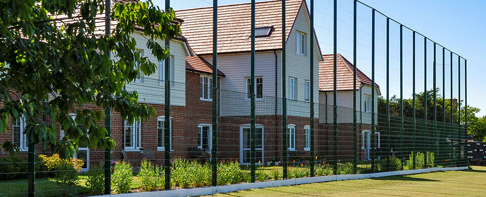 Extra High Sports Fencing Between Residential and Football Pitch